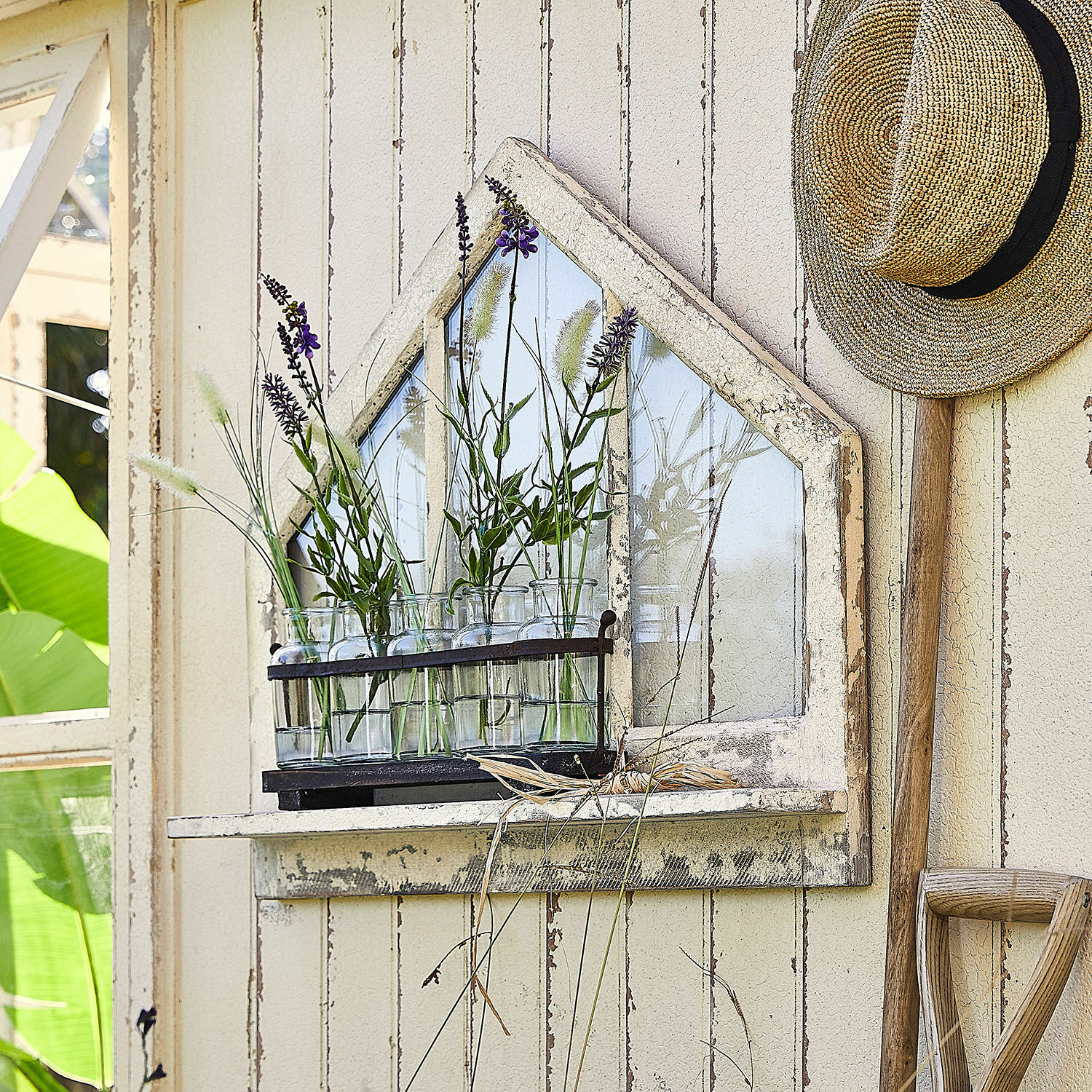 Étagère murale Northwick Étagère murale en bois rustique avec miroir et bouteilles en verre contenant des plantes vertes dans un jardin