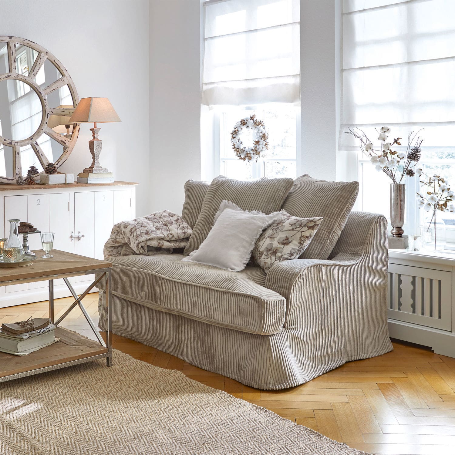 Bank Monaco Beige ribfluwelen bank in lichte woonkamer met natuurlijke decoraties en jute vloerkleed