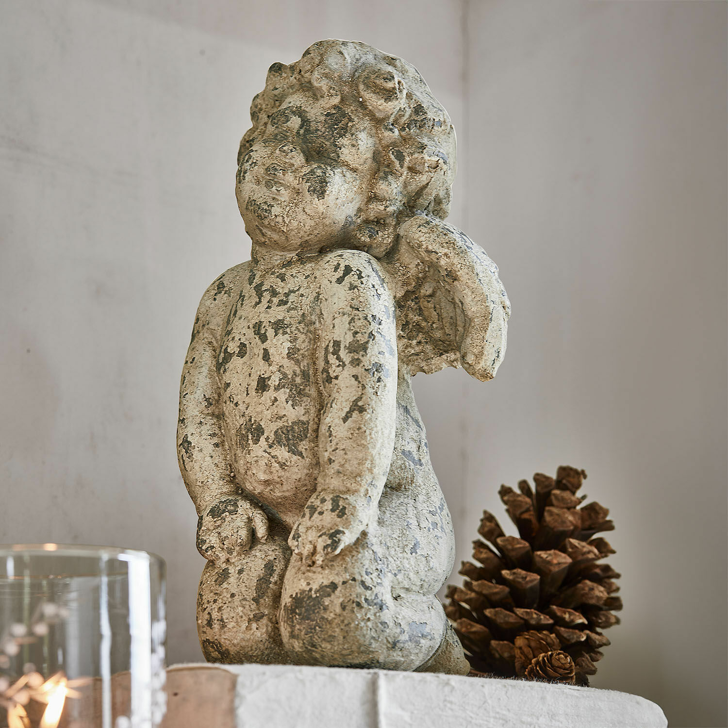 Decoratieve engel Mines Beeldje van engel van verouderd beige steen, interieurdecoratie met natuurlijke dennenappel