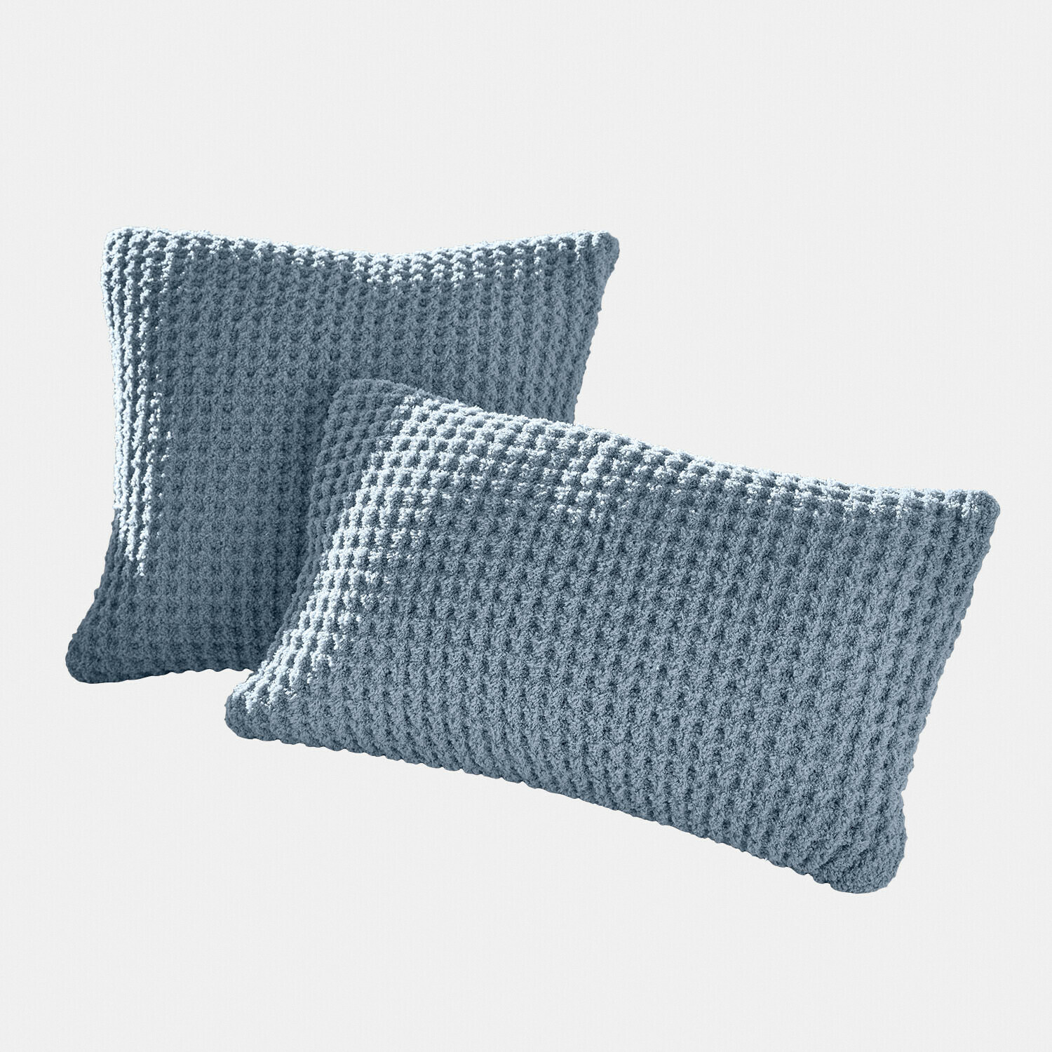 Deux coussins bleus en tissu tricoté doux avec texture gaufrée pour décoration intérieure