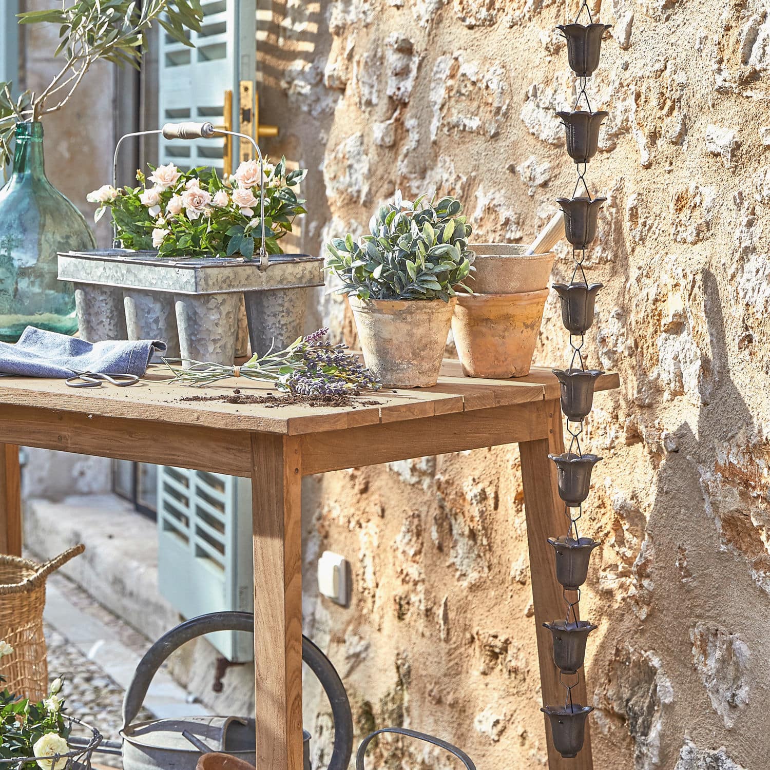 Chaîne de pluie Shimon Table de jardin en bois avec pots en terre cuite et jardinière en métal dans un cadre rustique