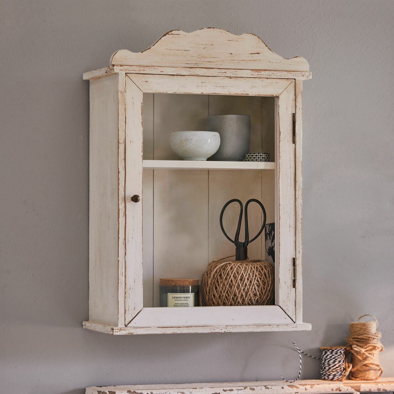 Wandkastje Sandrine Wandkast van wit hout in vintage stijl met glazen deur en decoratieve voorwerpen binnenin