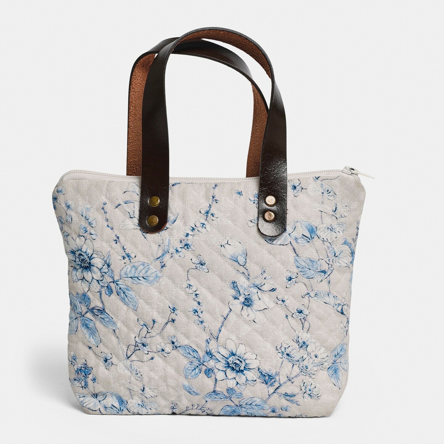 Tas Vailenne Beige gewatteerde tas met blauw bloemenpatroon en zwarte leren handvatten, modieuze accessoire