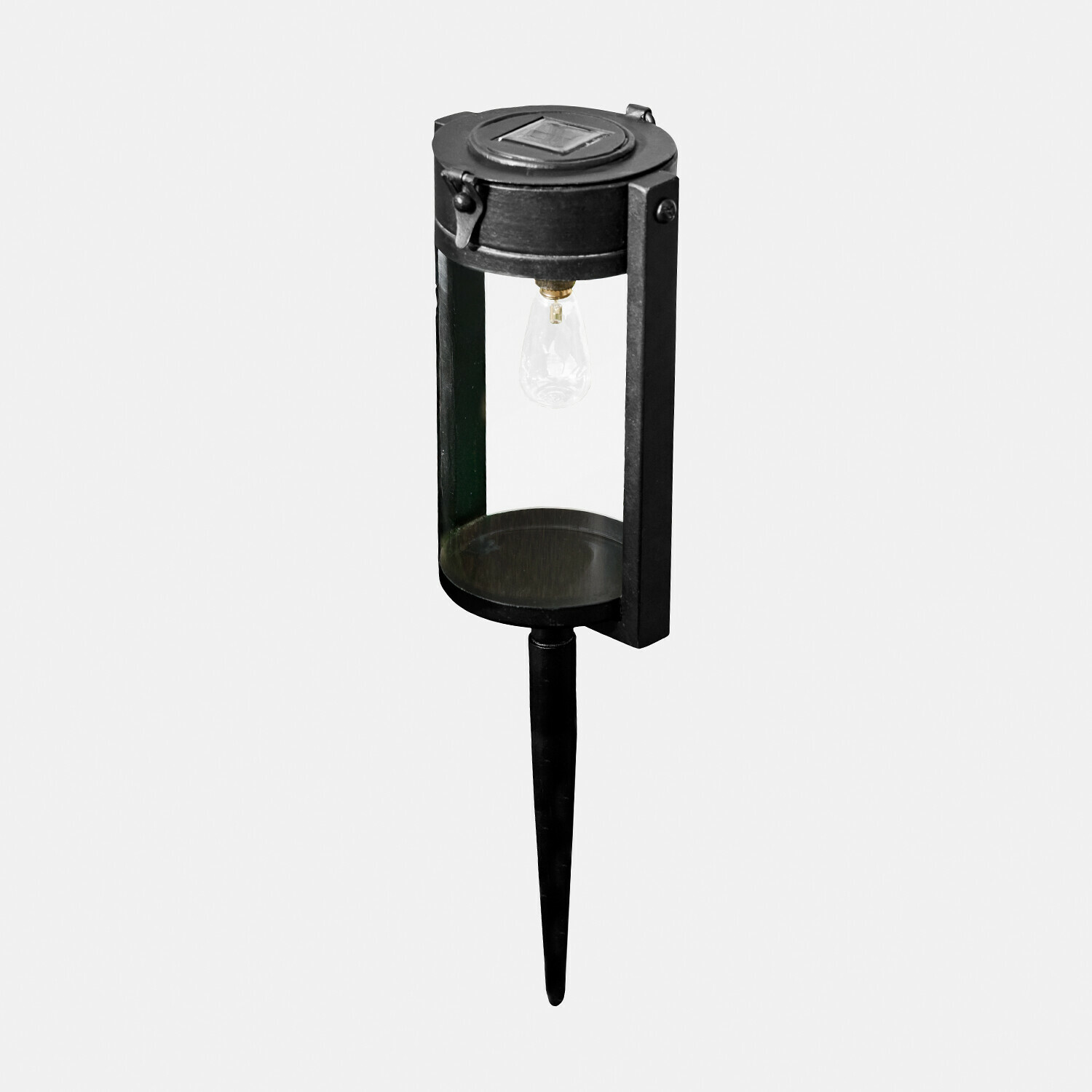 Zwarte metalen tuinlamp met doorzichtige kap en grondpin om in de aarde te steken