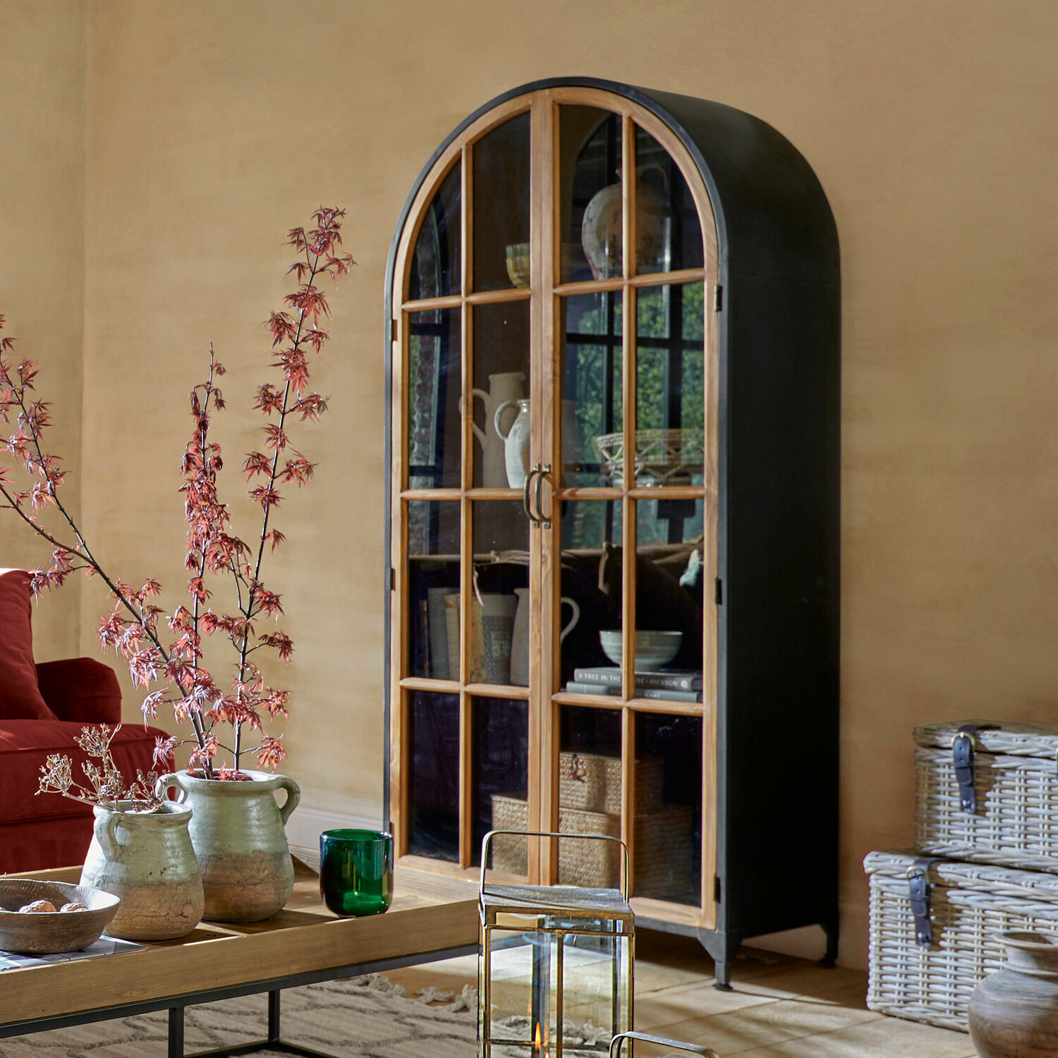 Buffetkast Mardilly Kast met afgerond zwart metalen frame en houten deuren met glas in een woonkamer