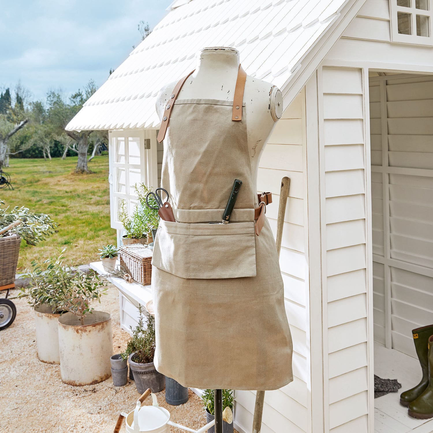 Beige katoenen tuinschort met leren banden en zak voor tuingereedschap