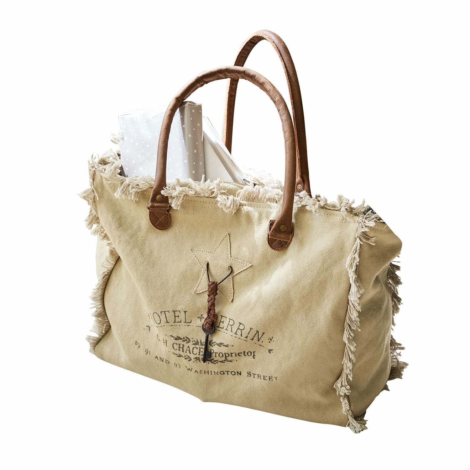 crème Elora tas van crèmekleurige stof met bruine handvatten en decoratieve franjes, vintage stijl
