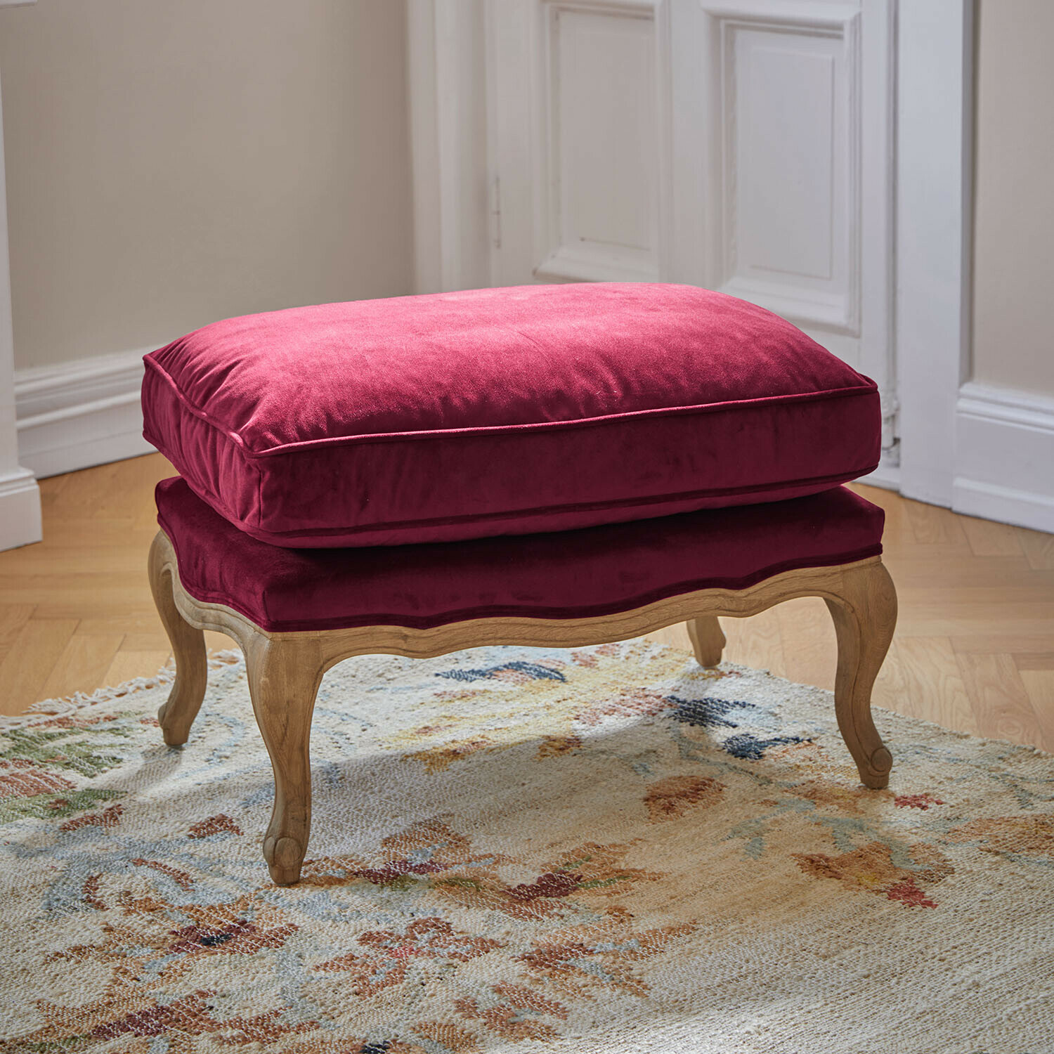 Tabouret Corlay Repose-pieds en bois avec coussin en velours bordeaux, parfait pour un salon élégant