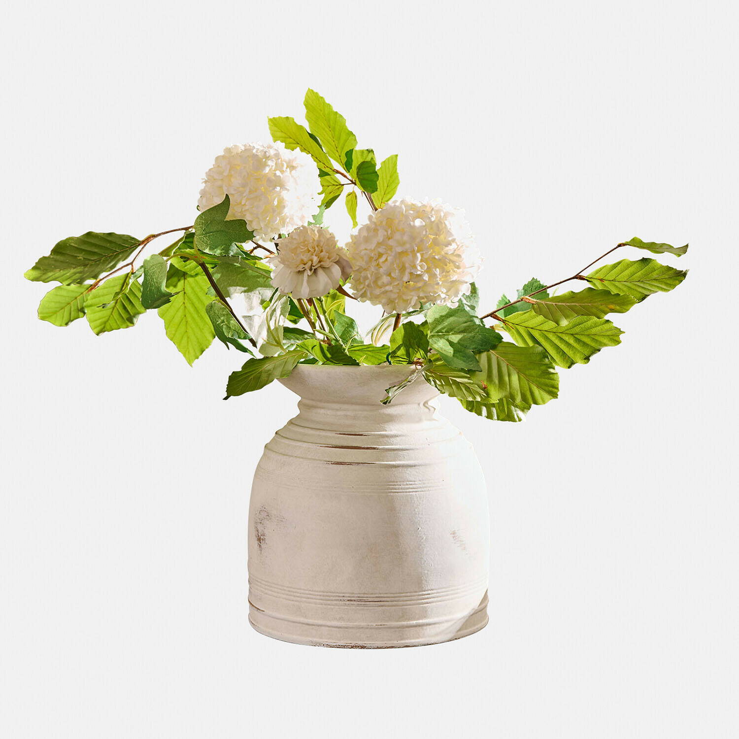 Vase en céramique blanche avec feuilles vertes et fleurs blanches décoratives pour intérieur