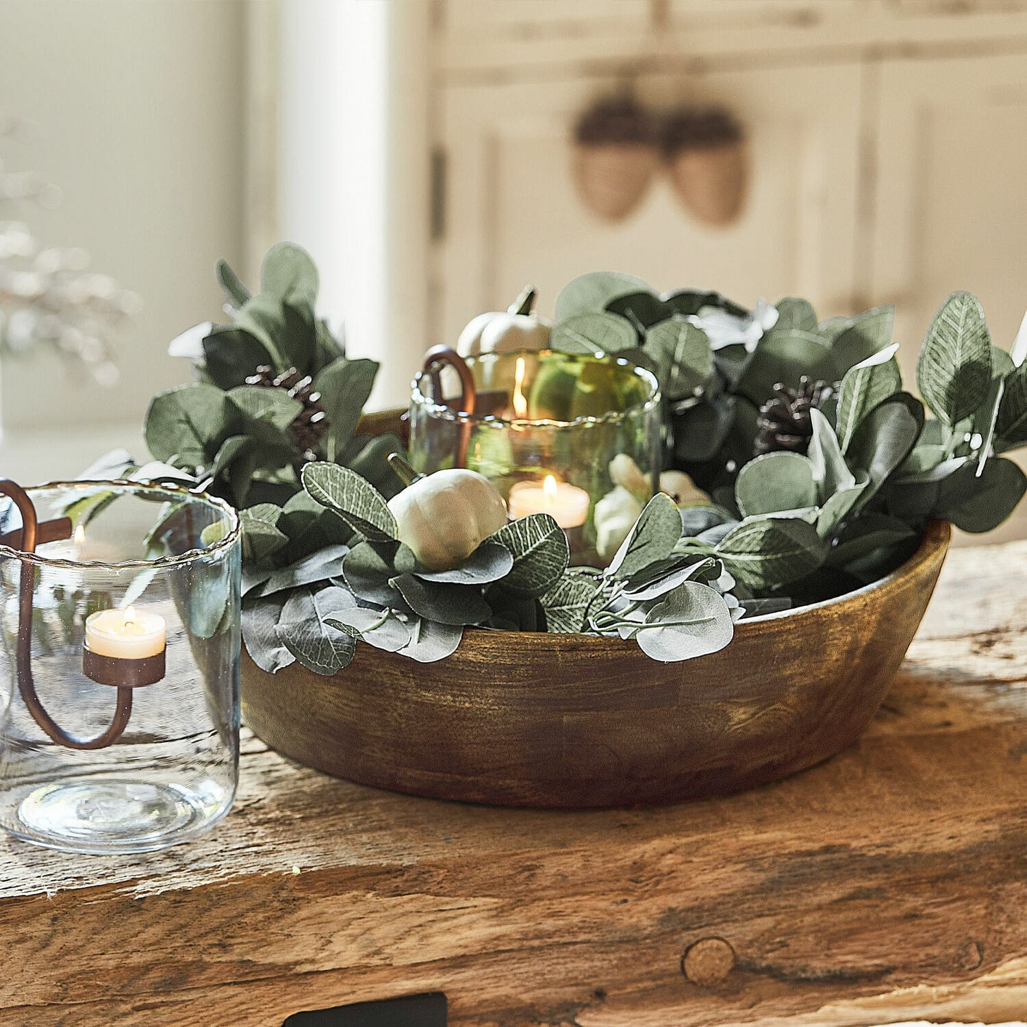 Guirlande Belfays Decoratieve houten schaal met groene bladeren en kaarsen in glazen houders op tafel