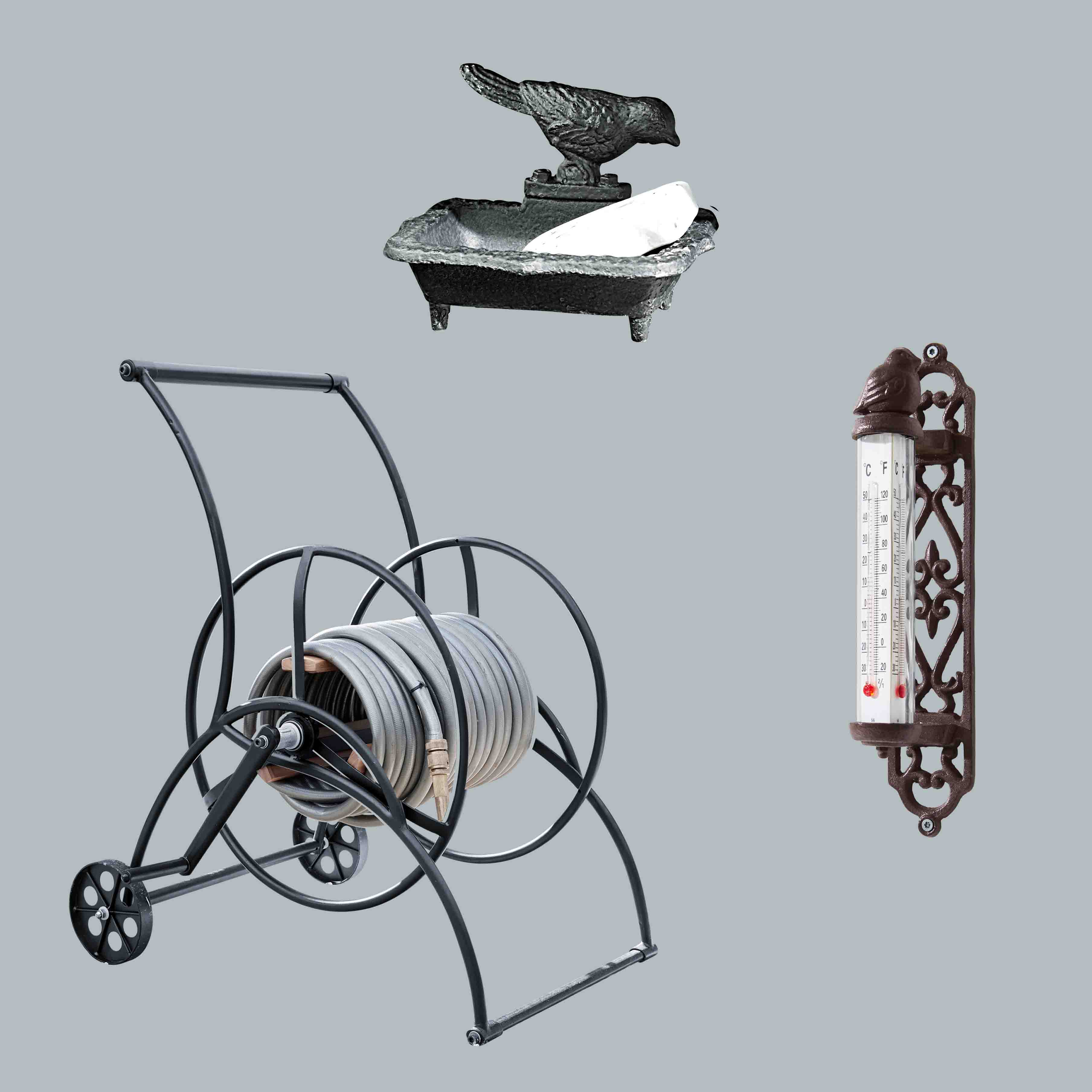 Metalen tuinslangwagen met grijze slang, gietijzeren zeephouder en vogelthermometer