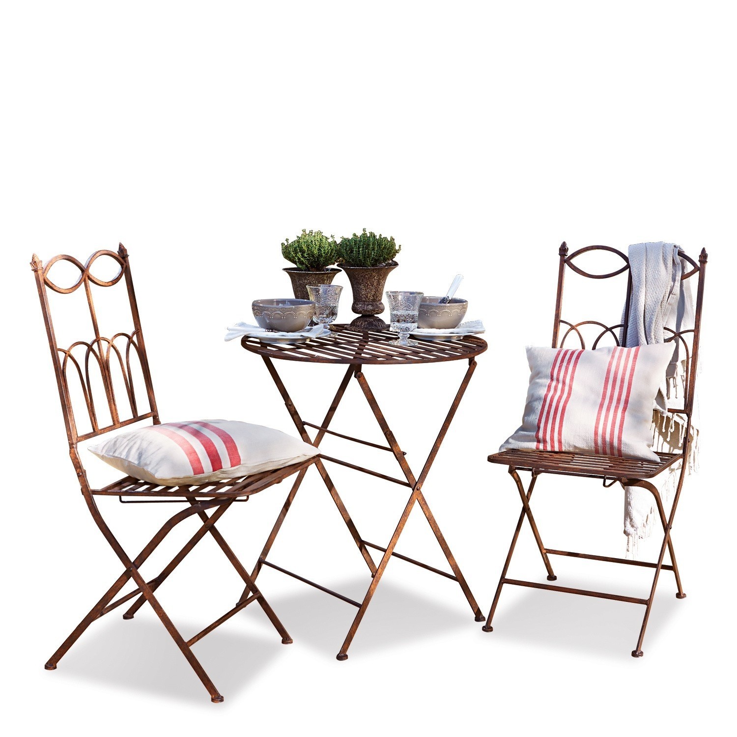 Tuinset Fieldbrook Tuinset van roestig metaal met kussens met rode strepen en decoraties op tafel