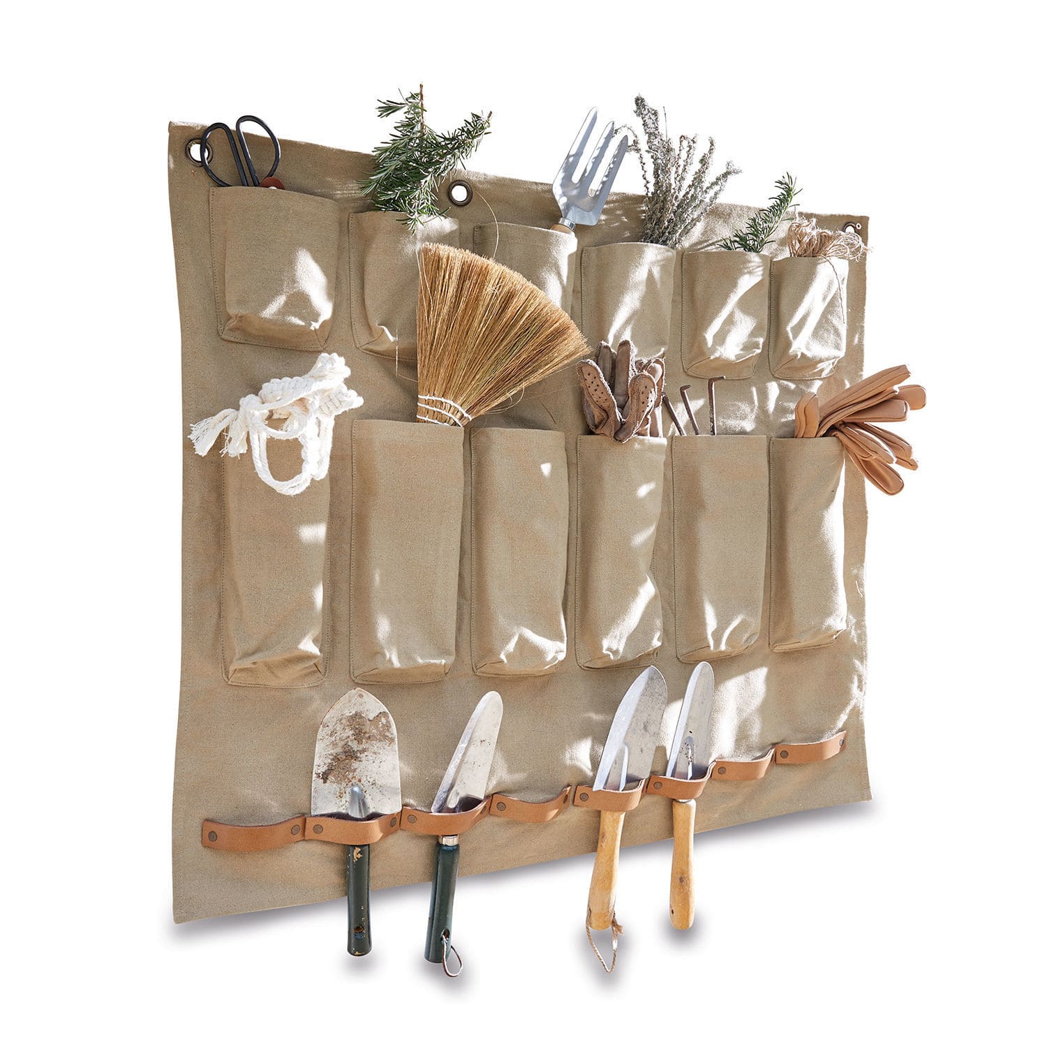 Beige stoffen organizer met zakken en leren houders voor tuingereedschap