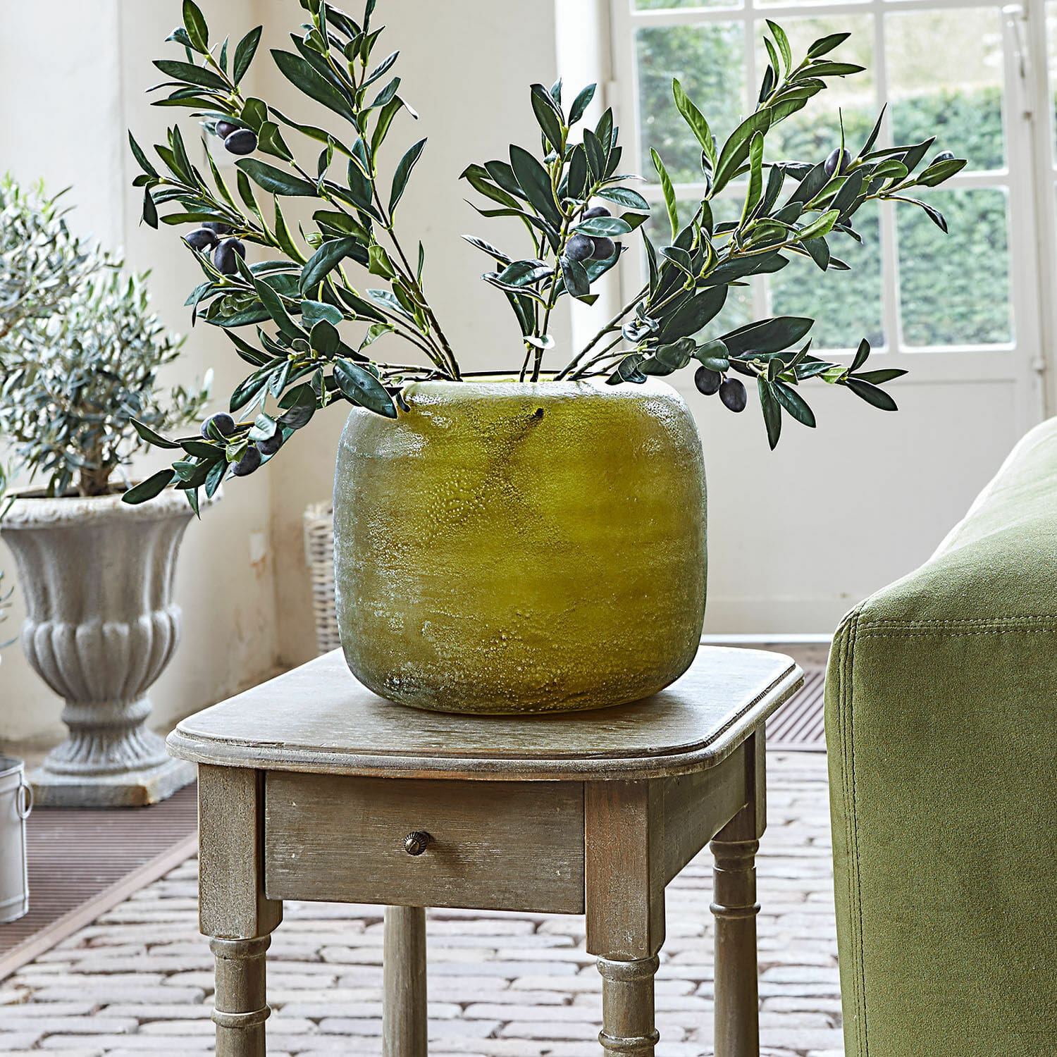 Vase Hilvento Vase en céramique verte sur une table en bois avec branches d'olivier décoratives dans un intérieur lumineux