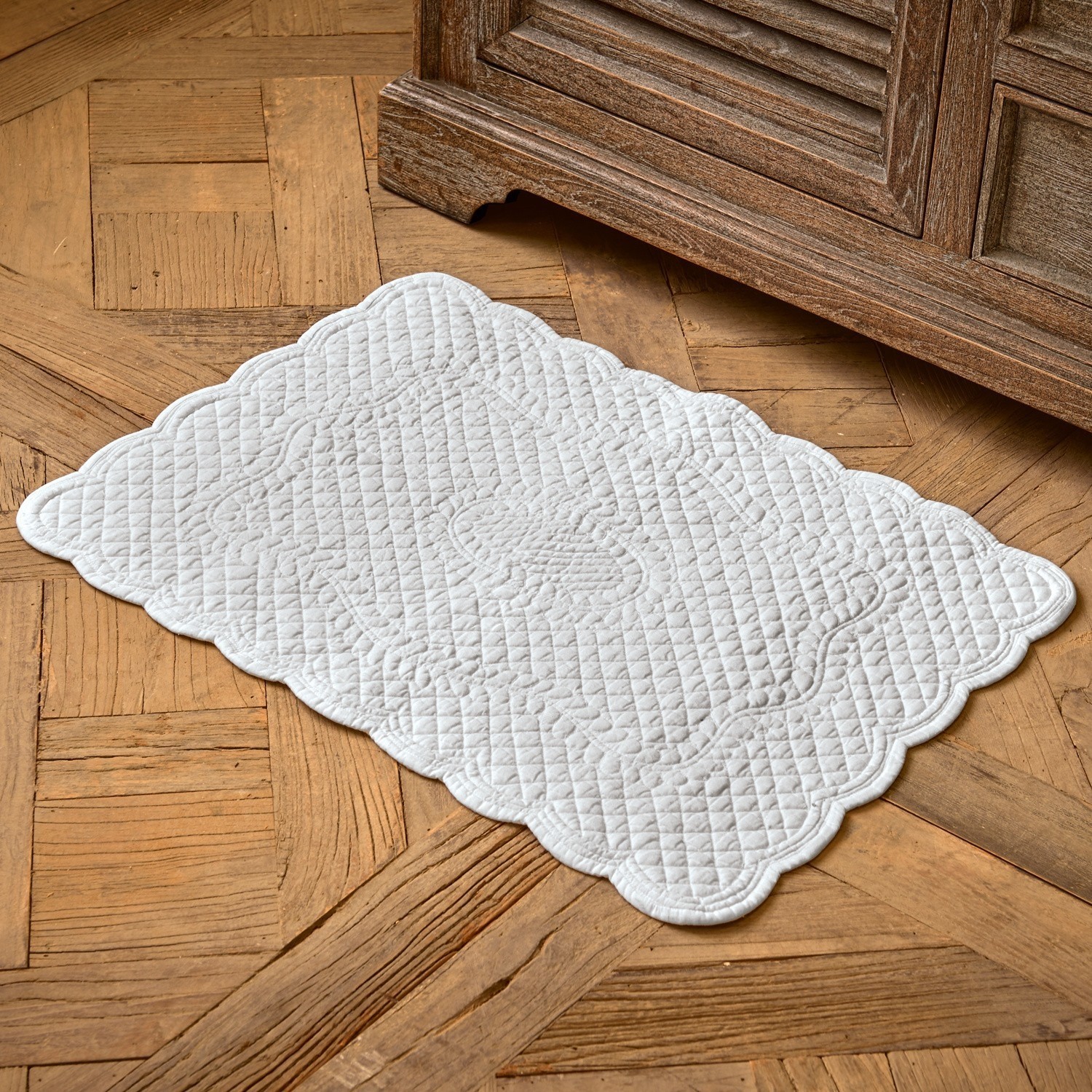 Badmat Meggie Witte gewatteerde katoenen vloerkleed met decoratief patroon op houten vloer, interieurdecoratie