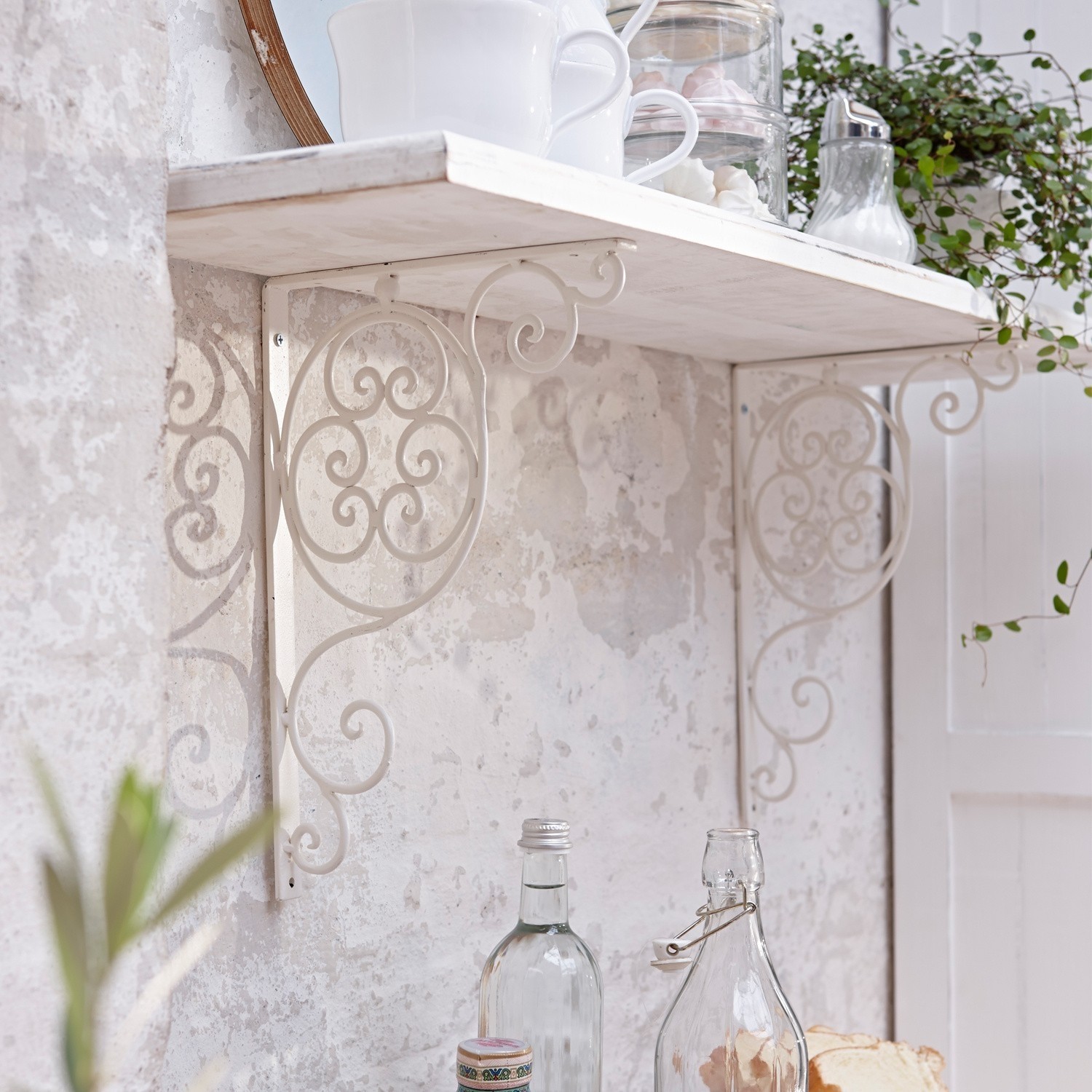 Witte metalen wandplank met decoratieve vintage beugels voor keuken of woonkamer