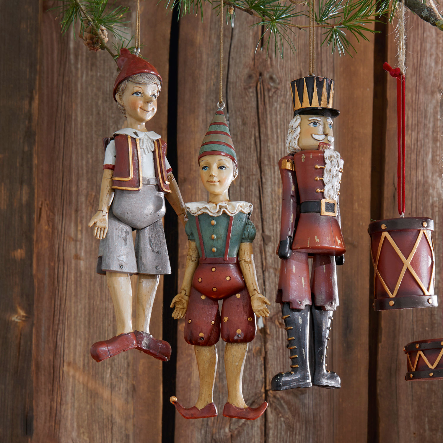 Houten kerstversieringen met figuren van Pinokkio en soldaat in rood- en groentinten
