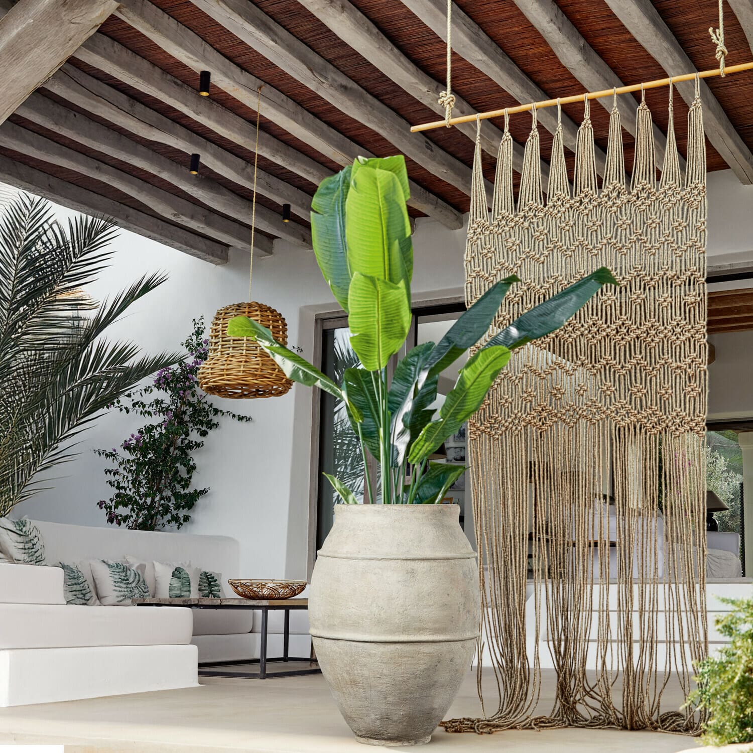 Sierplant Lennidas Grote lichte stenen pot met groene plant in moderne woonkamer met macramé en rotan lamp
