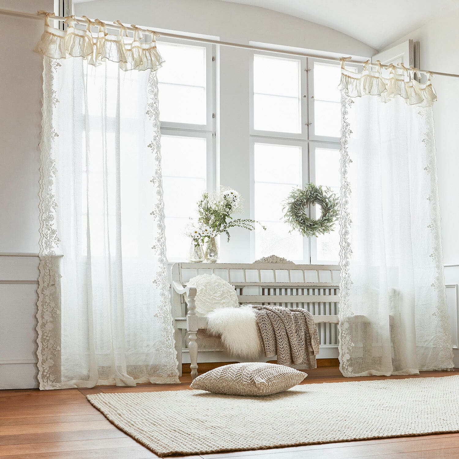 Voilage Denise Rideaux blancs transparents avec bordure en dentelle dans un salon lumineux au sol en bois
