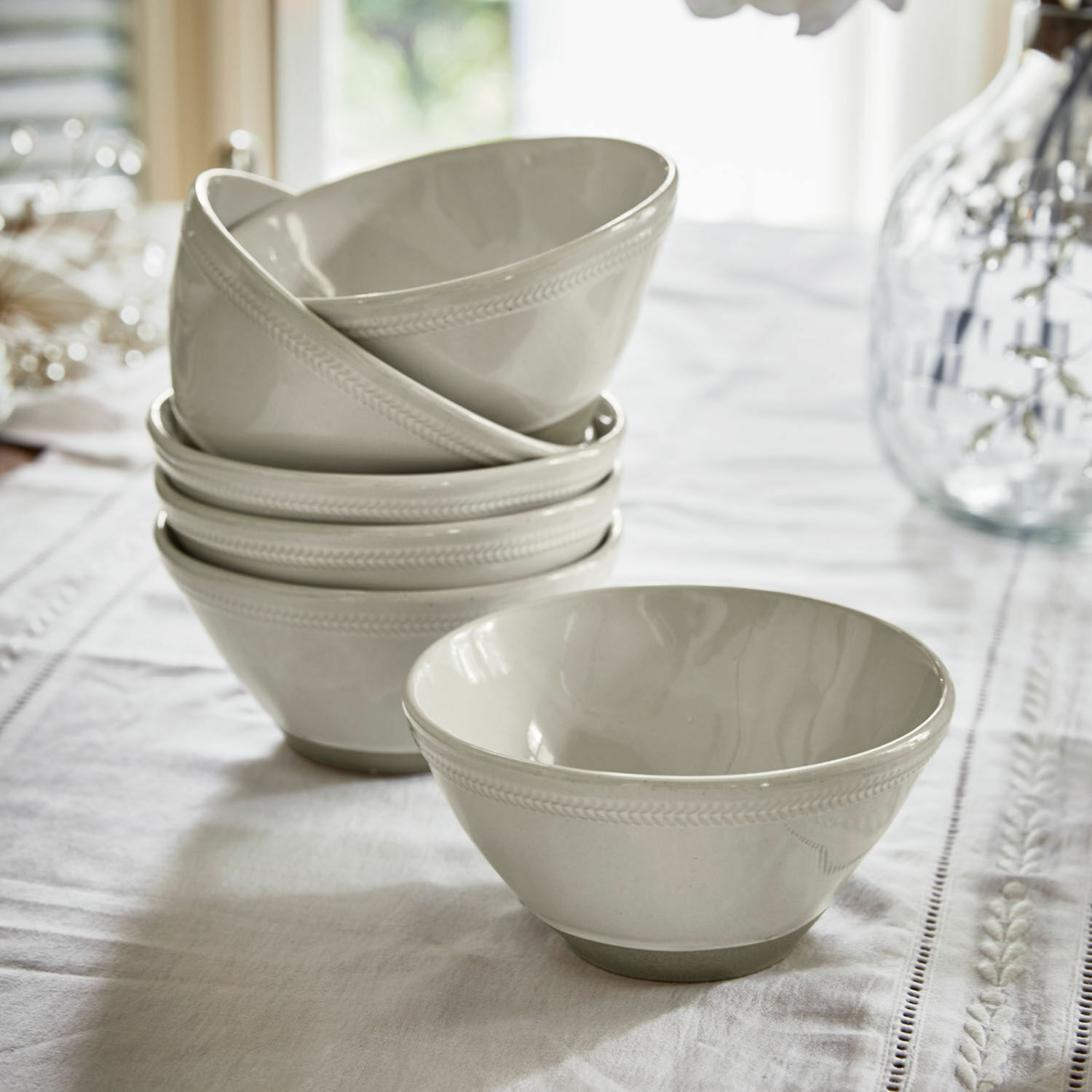 Lot de 6 bols Norrvik Ensemble de bols en céramique blanche avec motif discret sur le bord, posés sur une nappe