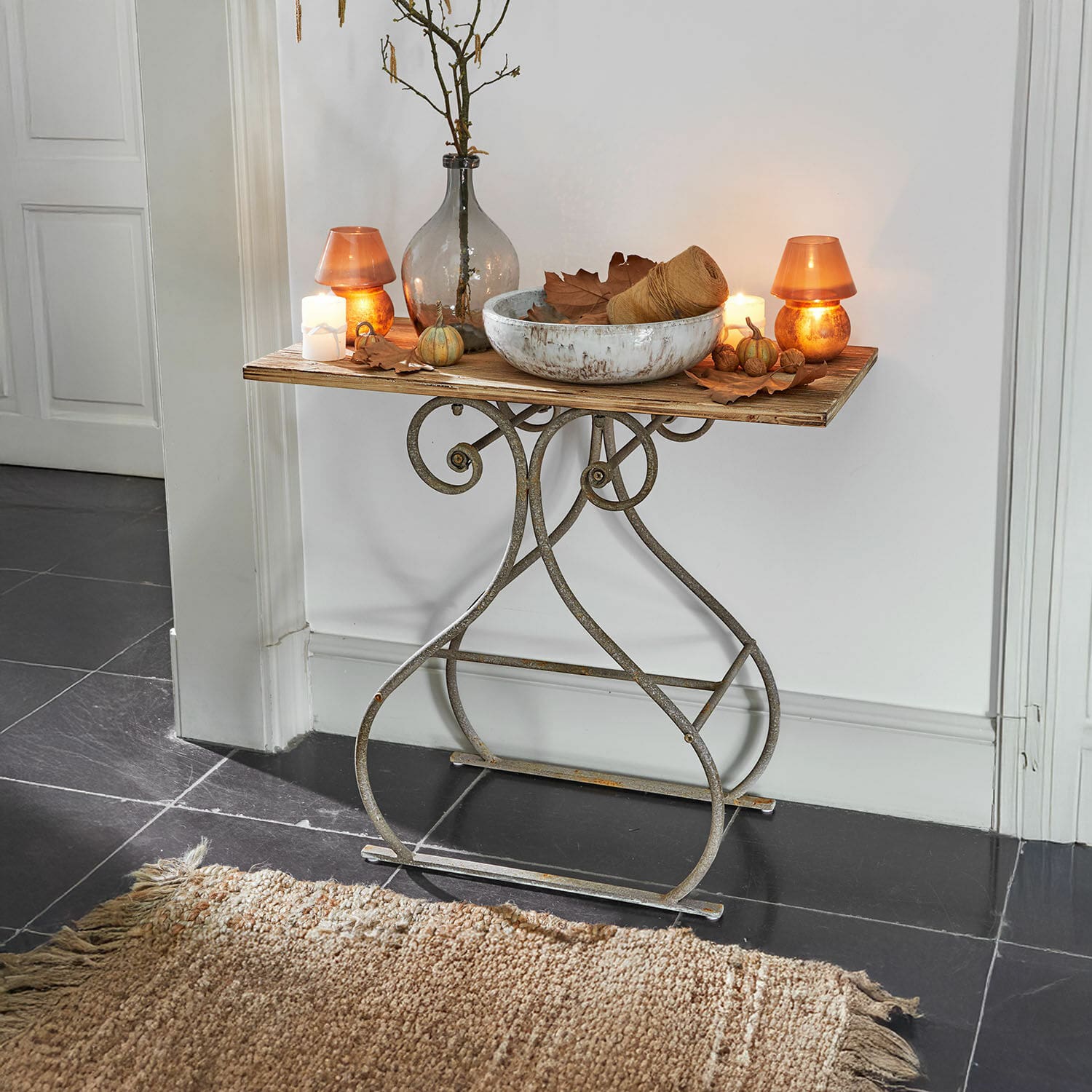 Console Clermontis Table avec base en métal et plateau en bois décorée de bougies et vase style vintage