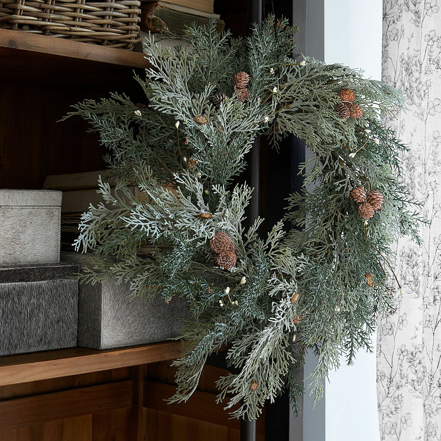 Couronne Privena Couronne décorative en branches vertes et pommes de pin dans un style naturel sur un mur
