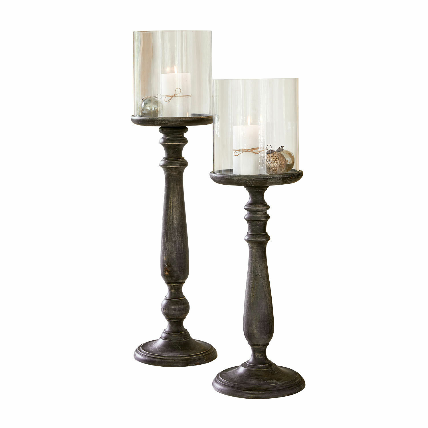 Lot de 2 bougeoirs Reville Deux grands bougeoirs en bois foncé avec abat-jours en verre transparent et bougies blanches