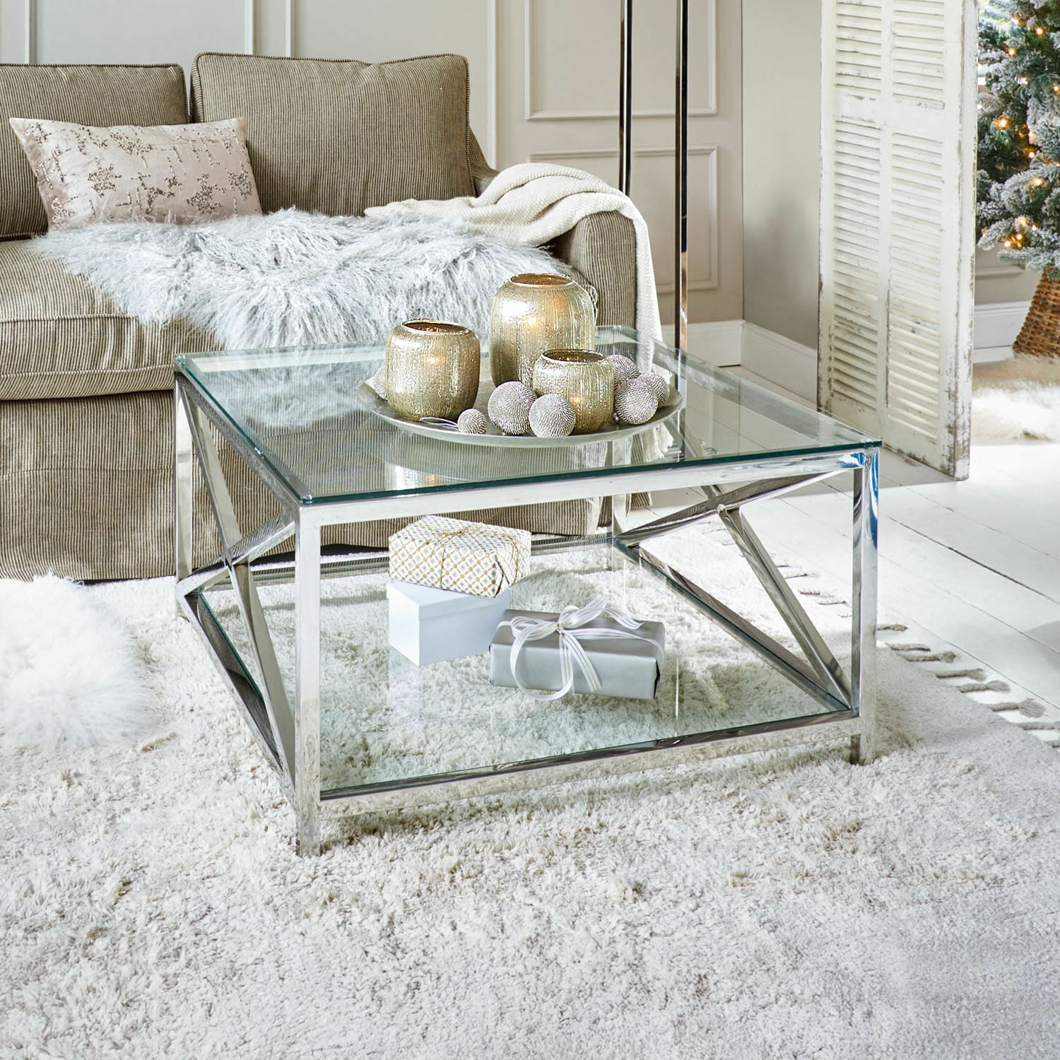Salontafel Stamford Moderne glazen salontafel met zilverkleurig metalen frame op lichte vloerkleed in woonkamer