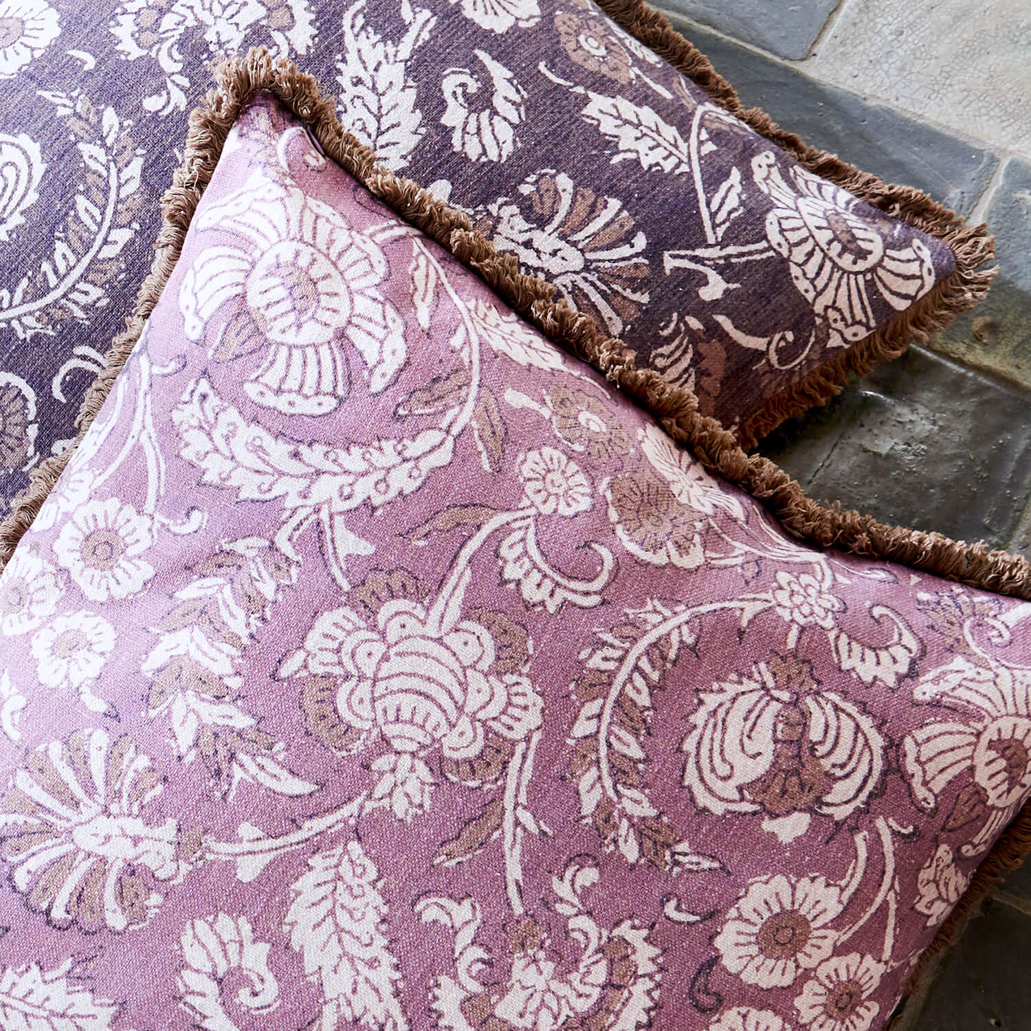 Coussin décoratif réversible en coton violet et marron avec motifs floraux et franges