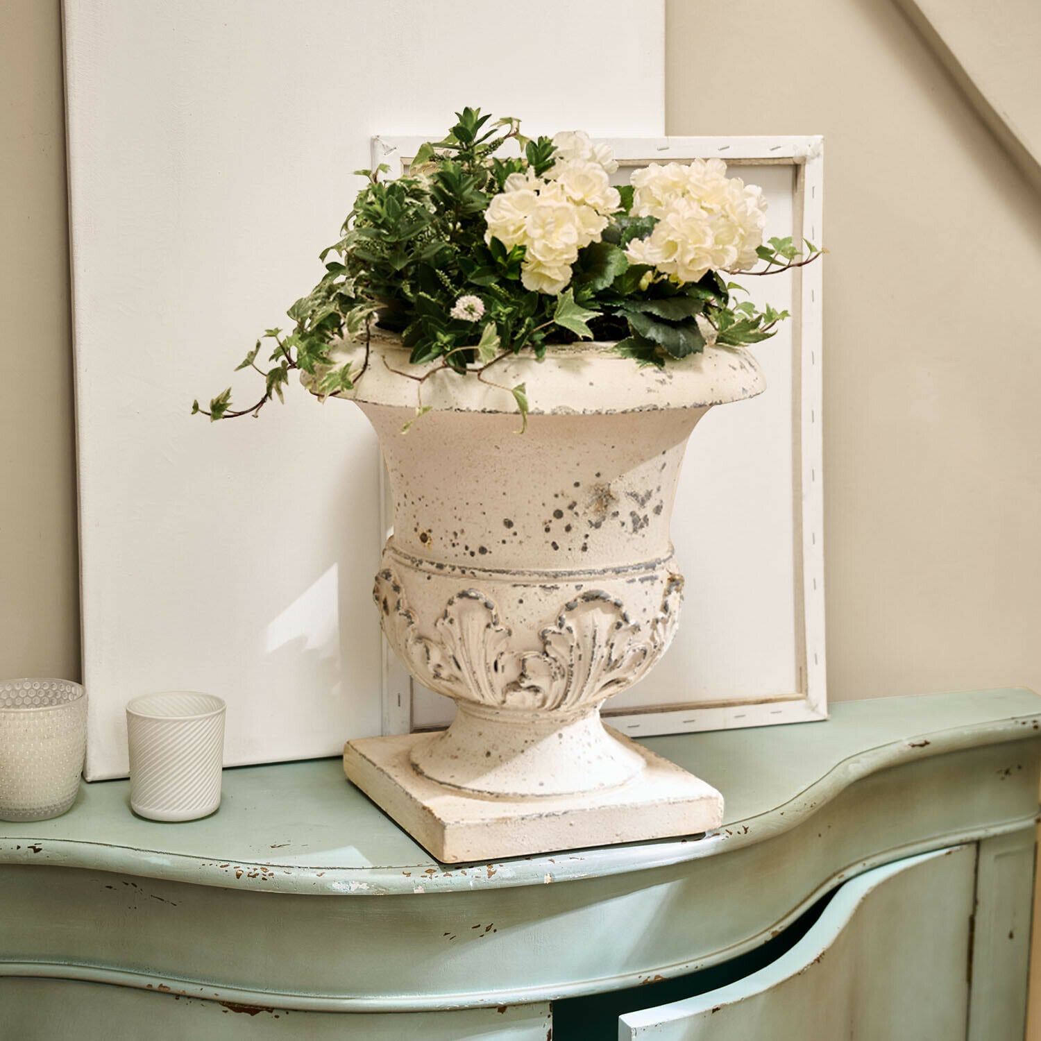 Amfora Lorianza Witte keramische vaas met plantenarrangement op groene vintage kast met verweerde look