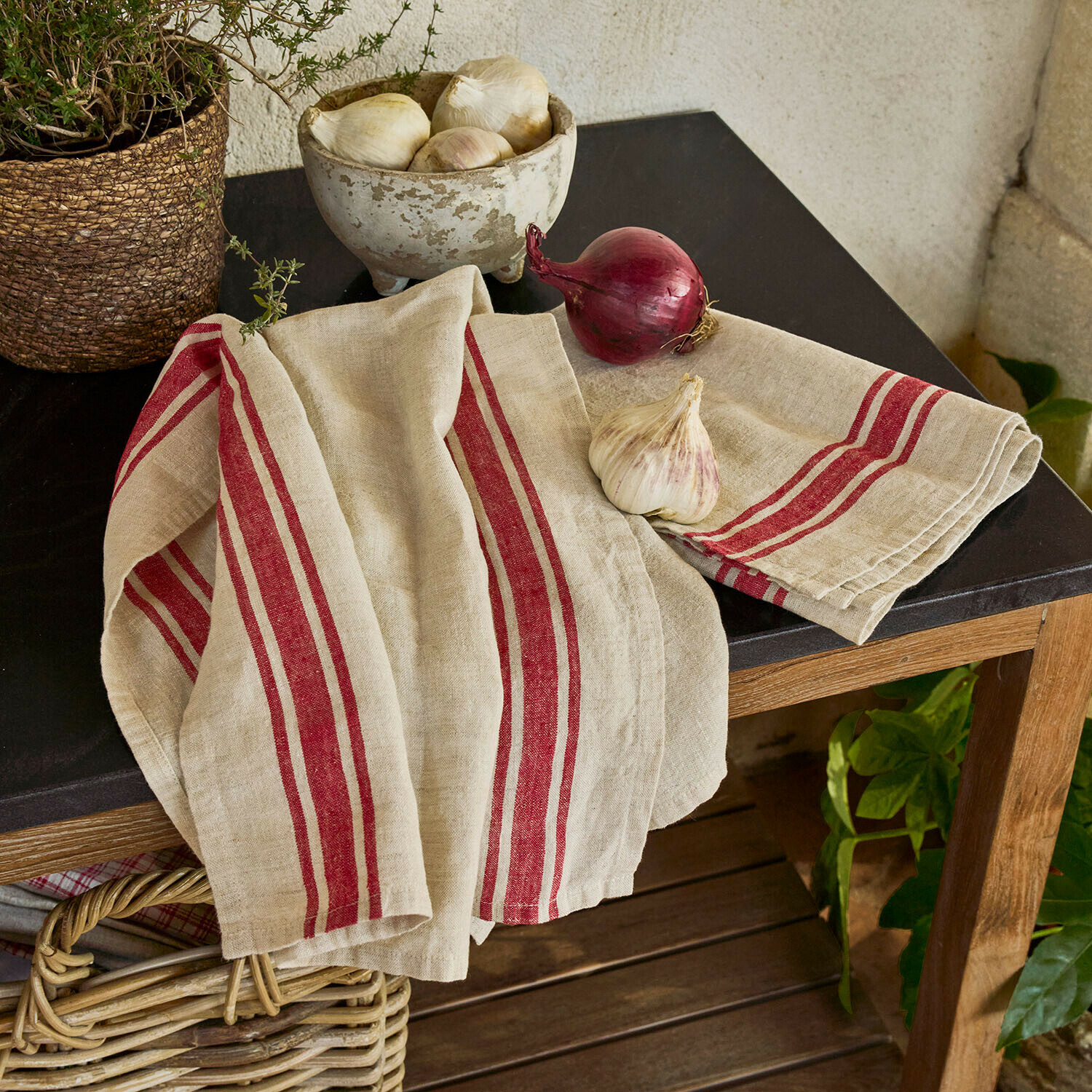 Theedoek set van 2 Norisse Beige linnen keukendoek met rode strepen op houten tafel met zwart blad